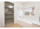 Bright bathroom featuring a soaking tub and a window with a view of the outdoors at 8224 Cassis Ct, Las Vegas, NV 89117