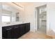 Bathroom features a double sink vanity with dark cabinets and a walk-in closet at 8224 Cassis Ct, Las Vegas, NV 89117
