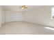 Bedroom featuring neutral carpet, ceiling fan, double doors, and a window at 8224 Cassis Ct, Las Vegas, NV 89117
