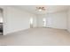 Expansive bedroom with neutral carpet, ceiling fan, and access to balcony via double doors at 8224 Cassis Ct, Las Vegas, NV 89117