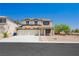 Inviting two-story home with neutral stucco, a welcoming porch, and low maintenance desert landscaping at 8224 Cassis Ct, Las Vegas, NV 89117