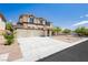 Charming two-story home with stucco exterior, three-car garage, and manicured landscaping at 8224 Cassis Ct, Las Vegas, NV 89117