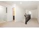Upstairs hallway features carpeted floors, and access to the laundry and bathroom at 8224 Cassis Ct, Las Vegas, NV 89117
