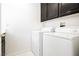 Bright laundry room features white washer and dryer at 8224 Cassis Ct, Las Vegas, NV 89117