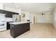 Open-concept kitchen and living room with modern finishes and light-colored wood floors at 8224 Cassis Ct, Las Vegas, NV 89117