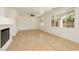 Bright living room with wood floors, a ceiling fan, and large windows overlooking the backyard at 8224 Cassis Ct, Las Vegas, NV 89117
