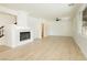 Open-concept living room with fireplace, recessed lighting, and expansive windows bringing in natural light at 8224 Cassis Ct, Las Vegas, NV 89117