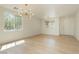 Sunlit living room featuring wood floors, recessed lighting, and large windows offering neighborhood views at 8224 Cassis Ct, Las Vegas, NV 89117