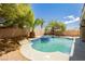 Backyard features desert landscaping, and a refreshing pool and spa at 8224 Cassis Ct, Las Vegas, NV 89117
