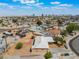 Expansive aerial view of a residential area with city skyline and blue skies in the background, showcasing neighborhood at 829 Dover Pl, Las Vegas, NV 89107