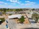 Aerial view of home with desert landscaping, fenced yard, and city views in the background at 829 Dover Pl, Las Vegas, NV 89107