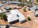 Aerial view of home with neutral stucco, white roof, desert landscaping, and private fenced yard at 829 Dover Pl, Las Vegas, NV 89107