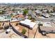 This aerial view shows a desert-landscaped home with a white roof, a circular patio, and a fenced yard at 829 Dover Pl, Las Vegas, NV 89107
