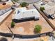 An aerial shot reveals desert landscaping in the spacious backyard, complete with an outdoor circular patio at 829 Dover Pl, Las Vegas, NV 89107