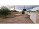 Backyard featuring gravel, a bush, and a view of the home at 829 Dover Pl, Las Vegas, NV 89107