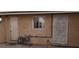 Exterior view of backyard with door, window and security gate on stucco house at 829 Dover Pl, Las Vegas, NV 89107