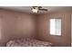 Bedroom with a window, ceiling fan and a patterned bedspread at 829 Dover Pl, Las Vegas, NV 89107