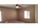 Cozy bedroom featuring a ceiling fan for comfort, and two windows for natural light at 829 Dover Pl, Las Vegas, NV 89107