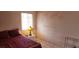 Bedroom featuring block wall construction, with tile flooring and a lamp on a side table at 829 Dover Pl, Las Vegas, NV 89107