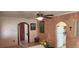 Unique dining room showcasing textured walls, rustic elements, and an arched entrance to the kitchen at 829 Dover Pl, Las Vegas, NV 89107