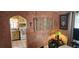 Rustic dining room with textured walls, decorative rug, table with flowers, and convenient access to kitchen at 829 Dover Pl, Las Vegas, NV 89107