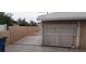 Driveway with a white metal driveway gate and cinder block wall at 829 Dover Pl, Las Vegas, NV 89107