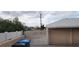 Driveway with a white metal gate and a block wall, with trash bins visible at 829 Dover Pl, Las Vegas, NV 89107