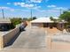 The house is an inviting home with a long driveway, mature trees, and a private, gated yard at 829 Dover Pl, Las Vegas, NV 89107