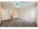 Spacious carpeted bedroom with ceiling fan, two doors, and one window at 830 Carnegie St # 824, Henderson, NV 89052