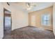 Carpeted bedroom with ceiling fan, window and access to the bathroom at 830 Carnegie St # 824, Henderson, NV 89052