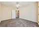 A neutrally decorated bedroom featuring carpeted floors, a ceiling fan, and a closet at 830 Carnegie St # 824, Henderson, NV 89052