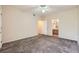 A neutrally decorated bedroom featuring carpeted floors, a ceiling fan, and access to the bathroom at 830 Carnegie St # 824, Henderson, NV 89052