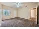 Carpeted bedroom with ceiling fan, natural light, and closet access at 830 Carnegie St # 824, Henderson, NV 89052