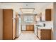 Functional kitchen features ample cabinet space, white appliances, and a bright window at 830 Carnegie St # 824, Henderson, NV 89052