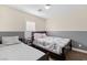 Bedroom with two beds, wood flooring, and natural light at 8336 Golden Amber St, Las Vegas, NV 89139