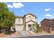 Two-story stucco home with a front-facing garage and mature trees in a suburban neighborhood at 8336 Golden Amber St, Las Vegas, NV 89139