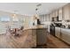 Stylish kitchen and dining area featuring gray cabinets, a stone-accented island, and modern appliances at 8336 Golden Amber St, Las Vegas, NV 89139
