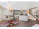 Updated kitchen with stainless steel appliances, an island, and adjacent dining area with chandelier at 8336 Golden Amber St, Las Vegas, NV 89139