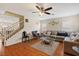 Cozy living room with hardwood floors, a gray sectional sofa, and bright natural light at 8336 Golden Amber St, Las Vegas, NV 89139