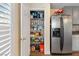 Pantry with metal rack shelving and stainless steel refrigerator at 8336 Golden Amber St, Las Vegas, NV 89139