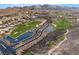 Community aerial featuring a pond, golf course, and desert landscaping at 9 Knob Oak Dr, Henderson, NV 89052