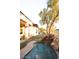 Lovely backyard pool with a rock waterfall next to a putting green with lush green grass at 9 Knob Oak Dr, Henderson, NV 89052