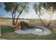 Backyard includes a calming rock waterfall feature next to a circular pool at 9 Knob Oak Dr, Henderson, NV 89052