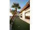 Backyard putting green next to home with large windows at 9 Knob Oak Dr, Henderson, NV 89052
