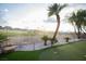Landscaped backyard featuring a putting green and view of neighboring properties beyond the fence at 9 Knob Oak Dr, Henderson, NV 89052