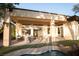 A beautiful covered outdoor patio featuring access to a private backyard pool and waterfall at 9 Knob Oak Dr, Henderson, NV 89052