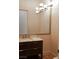 Well-lit bathroom with a modern vanity, elegant mirror, and marble countertop at 9 Knob Oak Dr, Henderson, NV 89052