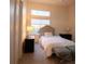 Well-lit bedroom with comfortable bed, side tables, and bench at 9 Knob Oak Dr, Henderson, NV 89052