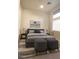 Modern bedroom with a stylish gray bed, contemporary artwork, and plenty of natural light at 9 Knob Oak Dr, Henderson, NV 89052