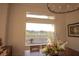 Bright dining area with a chandelier, large window with scenic views of the backyard, and elegant decor at 9 Knob Oak Dr, Henderson, NV 89052